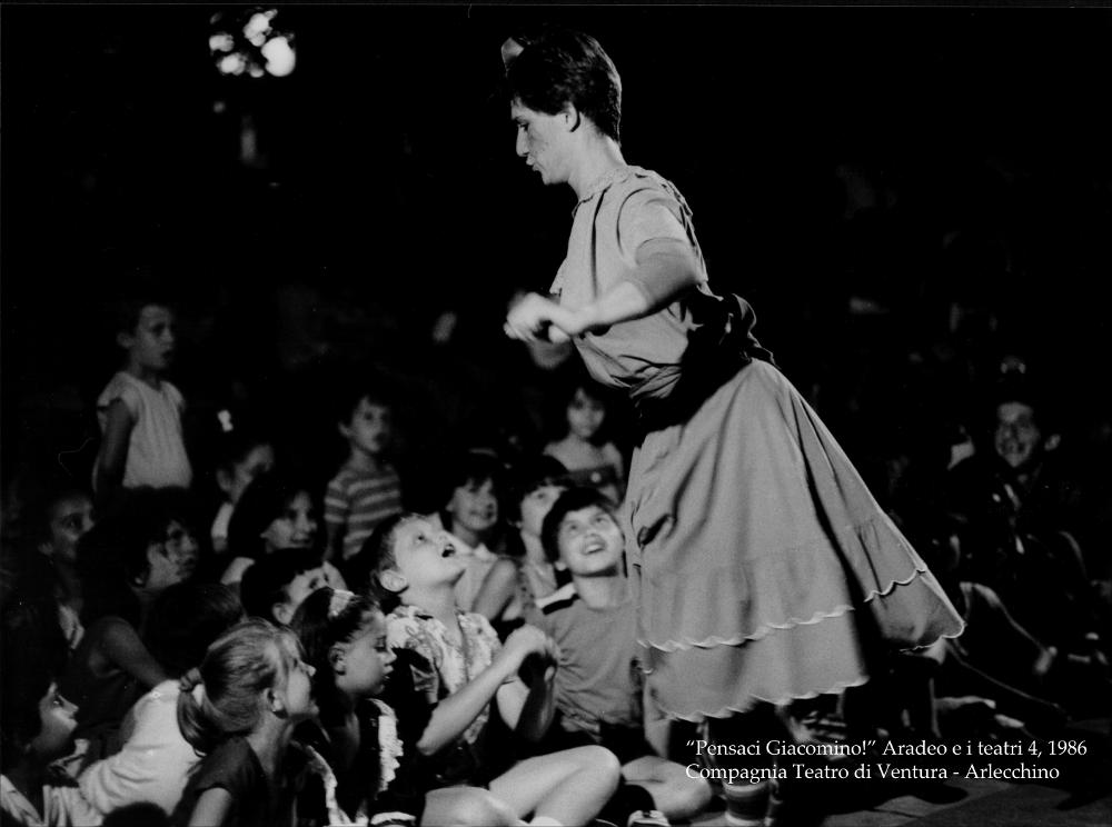 L'immagine digitale cattura uno dei momenti dello spettacolo teatrale “Arlecchino”, messo in scena nel 1986 nell'ambito della rassegna “Aradeo e i Teatri” inaugurata in quell'anno con il titolo “Pensaci Giacomino! Omaggio a Pirandello” per il cinquantenario della morte dello scrittore. La rassegna divenne un vero e proprio appuntamento con il teatro sperimentale che la compagnia del Teatro Koreja, nata nel 1983 nel piccolo borgo salentino di Aradeo, portò avanti sin dall'anno della sua fondazione. La performance si tenne in Piazzetta San Giovanni, inscenato dalla compagnia Teatro di Ventura. Lo spettacolo ha avvio da un naufragio immaginario che, avvenuto alle soglie del XXI secolo, porta inquinamento e la minaccia di una bomba atomica. Il protagonista Arlecchino, famos...