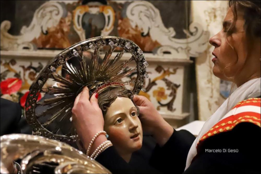 <div class="ql-editor"><div>Lo scatto fotografico immortala il momento della vestizione della Statua devozionale di Sant'Irene, Patrona della città di Altamura (BA), trasmettendo un senso di profonda devozione.</div><div>La festa patronale si celebra il 5 maggio con una Messa votiva e la tradizionale processione per le vie della città. Nel 1792 papa Pio VI concesse anche la celebrazione del Patrocinio della Santa il 16 agosto, ricorrenza che nel 1932 fu anticipata al 14 agosto. Nel 1937 Santa Irene venne proclamata Patrona Principale di Altamura, insieme a San Giuseppe.</div><div>Vergine e martire, Santa Irene è venerata fin dal V secolo, come testimoniano antiche chiese a lei dedicate a Costantinopoli e a Lecce. Ad Altamura il suo culto si sviluppò ...