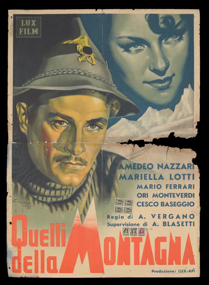 L'immagine riproduce una delle locandine conservate presso la Mediateca Regionale Pugliese (vedi Note). Si tratta di una delle versioni della locandina per il film "Quelli della montagna", a firma di Gargiulo (Gargiulo Sergio). Nonostante i tagli nella carta, si vede bene l'impianto compositivo, fatto di toni freddi che richiamano l'atmosfera tra i monti, esaltata da altri dettagli: le bianche cime al centro, che dividono in due parti la composizione, il cappello da alpino che indossa l'avvocato Fontana interpretato dall'attore Amedeo Nazzari e non in ultimo il titolo, in cui le forme di alcune lettere (si notino la grande M con le punte imbiancate, ma anche le A e le N) rafforzano visivamente l'idea di tutta l'ambientazione, come fosse un'altra immagine. Con questo imp...