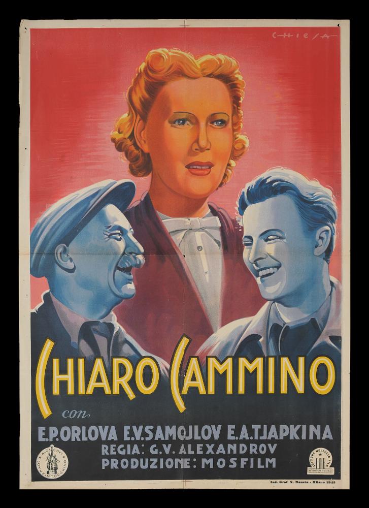 L'immagine riproduce uno dei manifesti conservati presso la Mediateca Regionale Pugliese (vedi Note). Si tratta di uno dei manifesti del film in bianco e nero “Chiaro cammino” del 1940 per la regia di Grigorij V. Aleksandrov . L'immagine riproduce uno dei manifesti conservati presso la Mediateca Regionale Pugliese (vedi Note). La composizione è a firma dell’illustratore Chiesa che ricorda per lo stile avanguardistico nel rappresentare i ritratti il collega di origini spagnole Anselmo Ballester. Protagonista indiscussa del manifesto è la figura femminile centrale, perfettamente centrale e punto luminoso della composizione. Particolari i tratti del volto, definiti anche dall’uso sapiente delle ombre che rendono il viso simile ad una maschera. Alla base del triangolo immag...