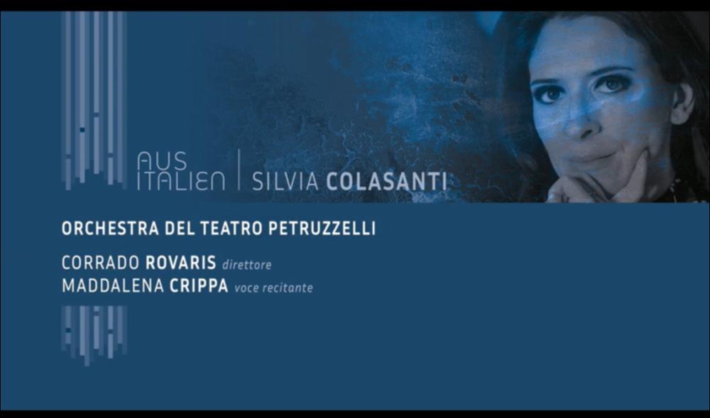 La serata del 28 giugno 2021 è stata inaugurata con l’incontro “Visti da vicino, video incontri con chi fa musica oggi”, un’interessante occasione di approfondimento con la compositrice Silvia Colasanti e l’attrice Maddalena Crippa, curato dal critico musicale Sandro Cappelletto.
Il concerto, per la rassegna musicale AUS ITALIEN, è stato dedicato alla musica della compositrice romana Silvia Colasanti, con trasmissione streaming del concerto.
In Programma l’esecuzione di “Orfeo, Flebile queritur lyra”, melologo per voce recitante e orchestra da camera (2017).
La musica di Silvia Colasanti intreccia uno strettissimo rapporto col mondo della letteratura e quello del teatro, tanto da riconoscere nelle sue composizioni una struttura drammaturgica, ripresa dal mito antico.
L’...
