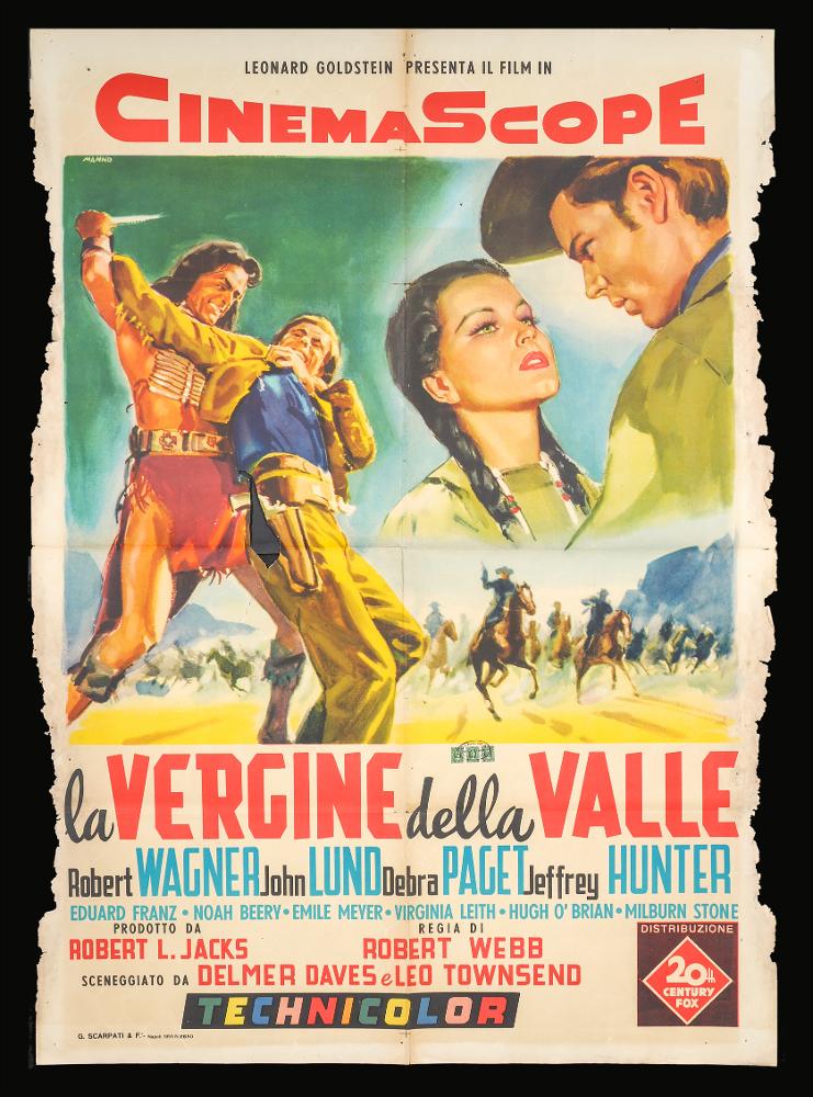 L'immagine riproduce uno dei manifesti conservati presso la Mediateca Regionale Pugliese (vedi Note). Si tratta di una delle versioni grafiche del manifesto del film western “La vergine della valle” del 1955 per la regia di Robert D. Webb. La firma che si legge in alto a sinistra è dell’illustratore Manno (Manno Dante), pittore formatosi all'Accademia di Belle Arti, dove fu allievo di Duilio Cambellotti. Questo influenzerà la sua carriera, dedicandosi totalmente alla pittura di cinema, sua grande passione fino alla crisi degli anni '70. L'uso degli acquerelli e della tempera, di colori compatti e pastosi rendono le sue figure ben definite e morbide, unendo un certo stile classico e accademico ad una grafica moderna. Manno, come molti altri pittori dell'epoca dediti alla...