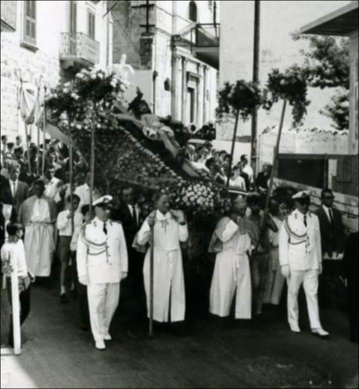 <div class="ql-editor"><div>Foto storica che ritrae la solenne processione del <strong>Santissimo Crocifisso</strong> per le vie di Rutigliano. In primo piano è visibile la venerata statua del Cristo crocifisso, portata a spalla tra la folla dei fedeli e accompagnata dalla partecipazione intensa della comunità, testimonianza della profonda devozione popolare legata alla tradizionale <strong>“Festa Grande”</strong> cittadina.</div><div><br></div><div>La <strong>Festa del Santissimo Crocifisso</strong> di Rutigliano, conosciuta come <strong>“Festa Grande”</strong>, è una delle celebrazioni religiose più importanti della Puglia. La sua origine risale al <strong>1876</strong>, quando la tradizione locale ricorda un evento ritenuto...