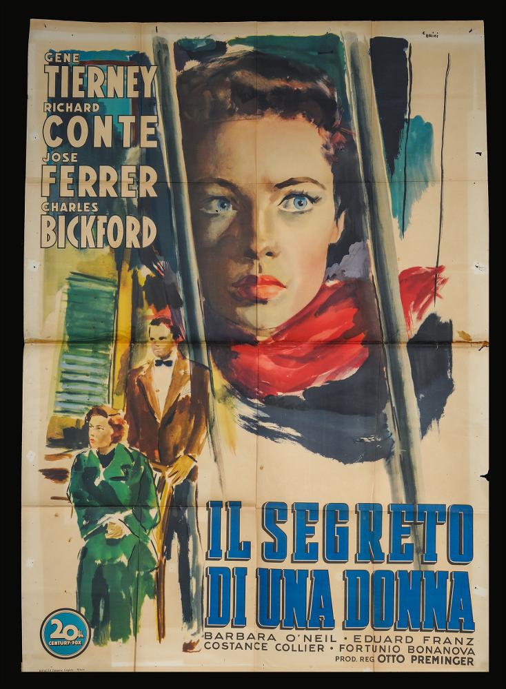 L'immagine riproduce uno dei manifesti conservati presso la Mediateca Regionale Pugliese (vedi Note). Si tratta di una delle versioni grafiche per il manifesto del film in bianco e nero "Il segreto di una donna" del 1949 per la regia di Otto Preminger, dal romanzo “Methinks the Lady” di Guy Endore. La grande illustrazione è a firma di Ercole Brini, (E. Brini) maestro romano dal linguaggio delicato, riconoscibile per l'uso degli acquerelli che rendono le figure e le ambientazioni rappresentate come impalpabili e cariche di fascino. L'attenzione del fruitore è catturata nell'immediato dalla bellezza femminile della protagonista Gene Tierney, esaltata nello sguardo, in primo piano dietro delle sbarre che richiamano una prigione. In piccolo e laterali Brini pone due persona...