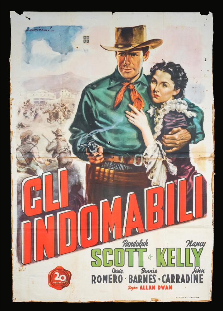 L'immagine riproduce uno dei manifesti conservati presso la Mediateca Regionale Pugliese (vedi Note). Si tratta di una delle versioni grafiche del manifesto del film "Gli indomabili", la cui illustrazione è a firma di Alfredo Capitani. Pittore di cinema del primo periodo, Capitani fondò uno studio nel 1919 per la realizzazione di manifesti pubblicitari e poi con Luigi Martinati una società per il lancio di pellicole cinematografiche. Il suo stile richiama quello di Ballester, con un uso di colori luminosi e sfumati con effetti di mirabile enfasi pittorica, data da contorni neri e netti che delineano le figure. Le sue rappresentazioni sono sempre originali, grazie all'uso di colori pieni arricchiti dalle loro variazioni tonali cangianti: per questa composizione, Capitani...